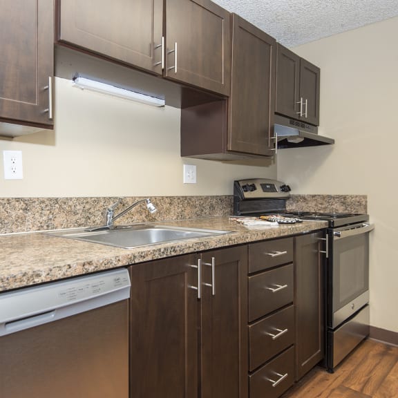 a kitchen with stainless steel appliances and granite counter tops