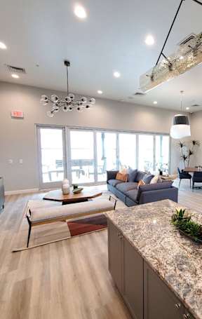 a dog laying on a couch with a girl on the couch in the background at Inspiration Apartments, AZ, 86326