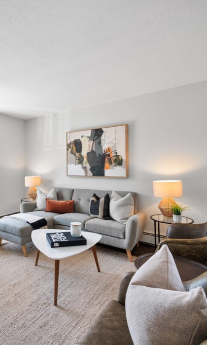 a living room with a large window and hardwood floors