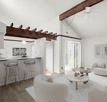 a living room with white walls and a ceiling with exposed beams