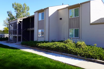 A building with a grey siding and a white roof.