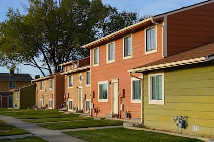 A row of houses with green lawns in front. at Willow Grove Apartments , Clifton, 81520