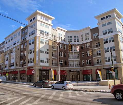 an image of a large apartment building on a city street