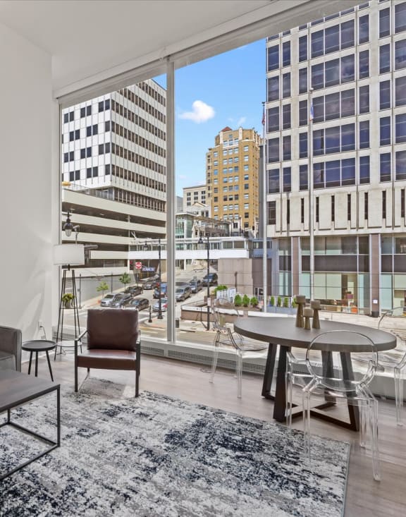 a living room with a large window and a view of a city