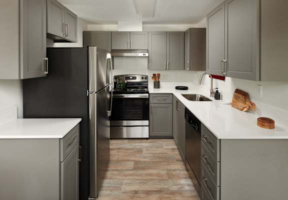 Kitchen with gray cabinets and stainless steel appliances at Cedar House, 98682