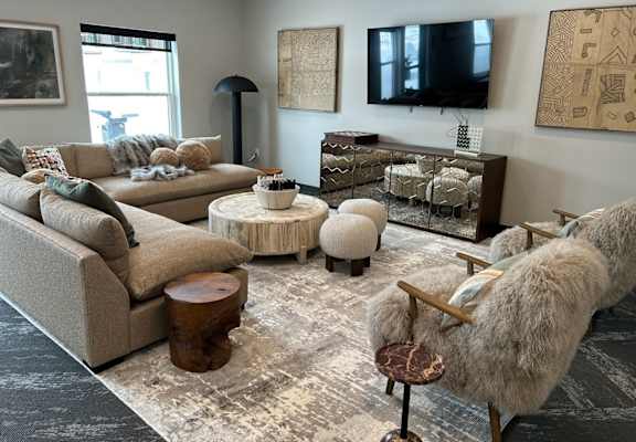 a living room with couches and chairs and a tv