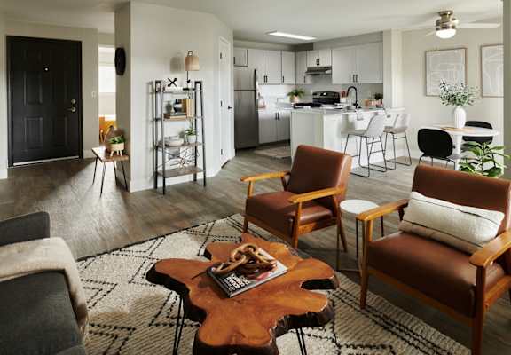 a living room and kitchen with a table and chairs