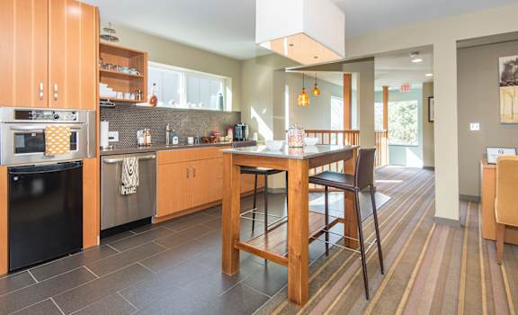 a kitchen with a large island and a table with chairs