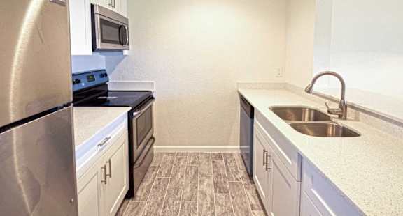 a kitchen with stainless steel appliances and a sink