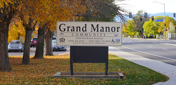 A sign for Grand Manor Community reads  at Grand Manor Apartments , Grand Junction