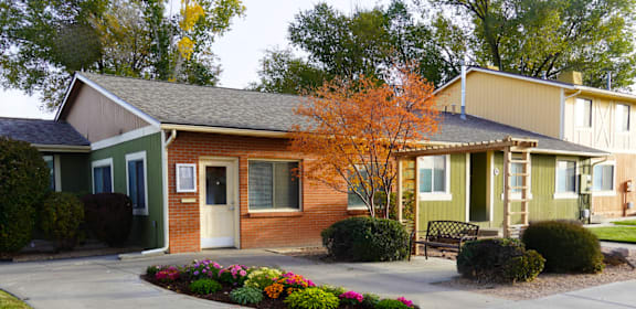 A small house with a brown door and a white door. at Willow Grove Apartments , Clifton, 81520