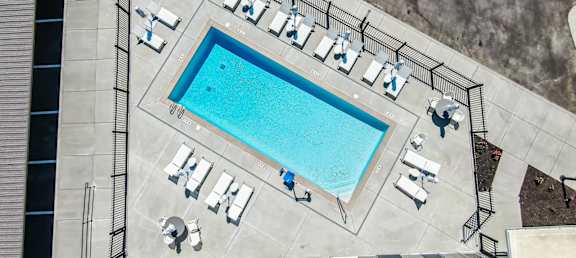 arial view of the pool and lounge area of a building with a swimming pool
