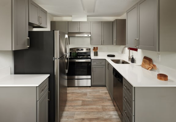 Kitchen with gray cabinets and stainless steel appliances at Cedar House, 98682