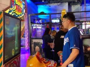 a young man playing a video game at an arcade