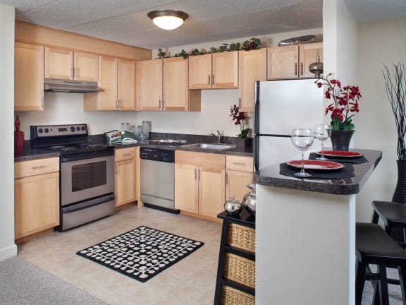 a kitchen with stainless steel appliances and wooden cabinets