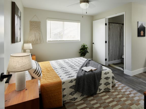 a bedroom with a bed and a ceiling fan