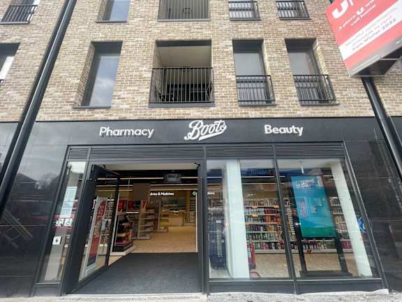 the front of a pharmacy store in a brick building
