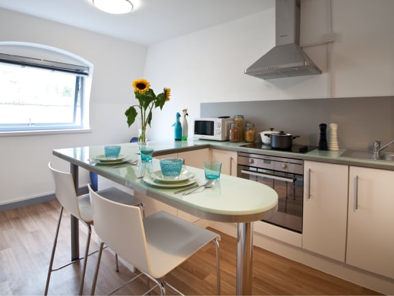 a kitchen and dining area with a table and chairs