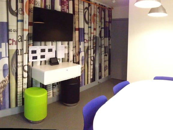 a room with a table and chairs and a television