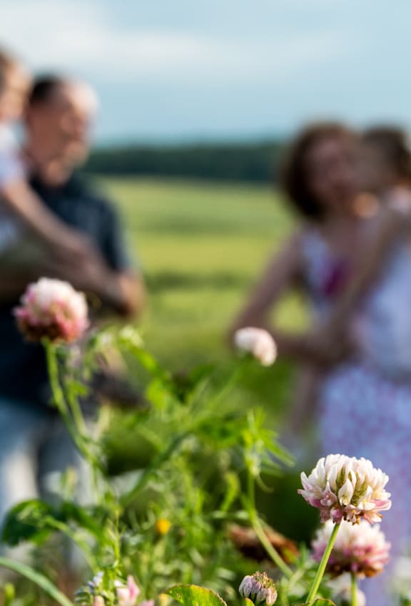 A couple is standing in a field of flowers.