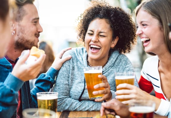 A group of people enjoying a meal and drinks together.