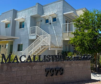 the front of a building with the mcalister street sign in front of it