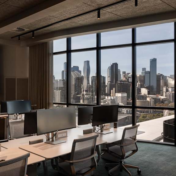 a laptop on a table in a room with chairs