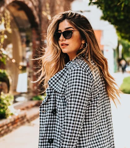 Woman Wearing Checkered Coat and Sunglasses