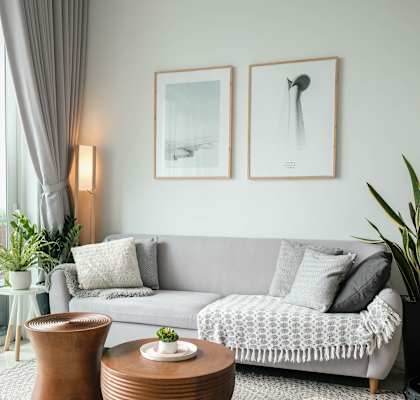 a living room with a grey couch and two coffee tables