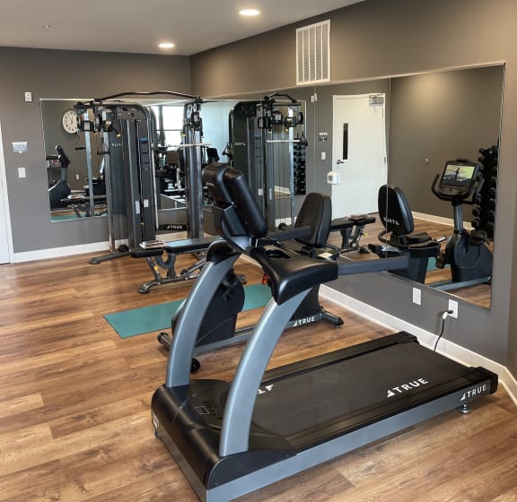 a gym with cardio equipment and mirrors at Adams Edge Apartments, Cincinnati