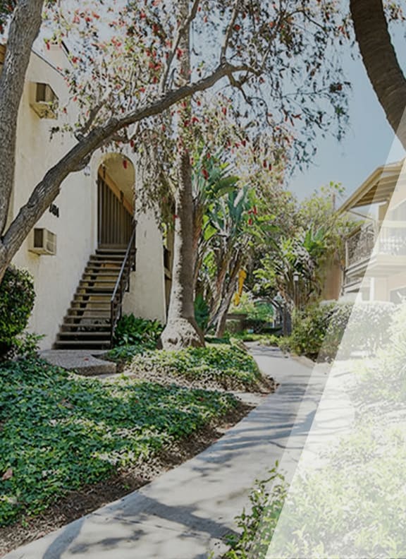 a view of a building with trees and a path