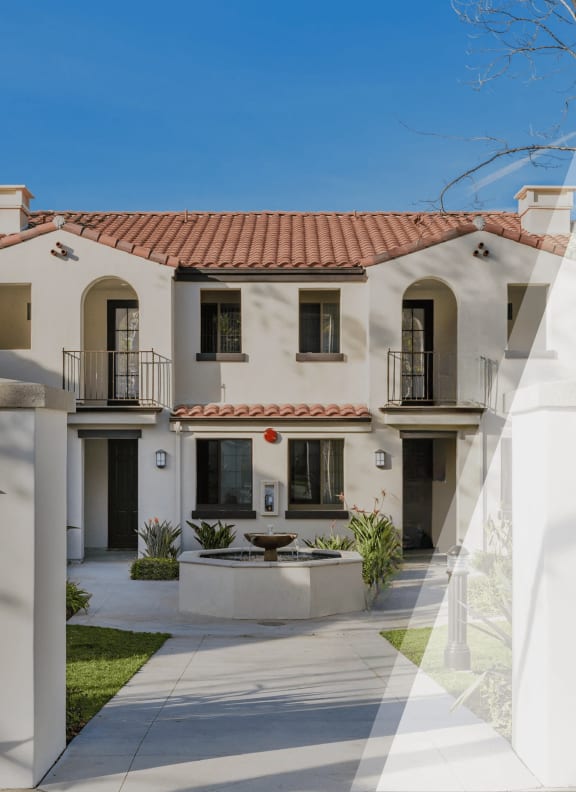 a white house with a patio and a courtyard