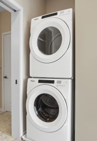 a washer and dryer stacked on top of each other in a laundry room