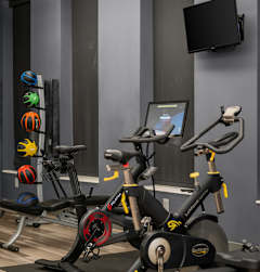Fitness center with treadmills and weight training equipment at The Flats at West End Apartments, Minnesota