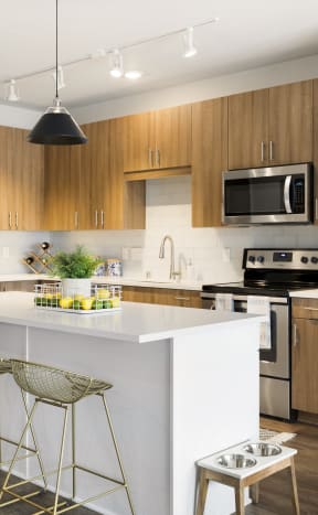 a modern kitchen with a white island and wooden cabinets