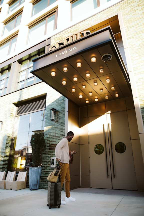 A man entering a building3 at Scout Living, powered by Placemakr, Atlanta, 30308