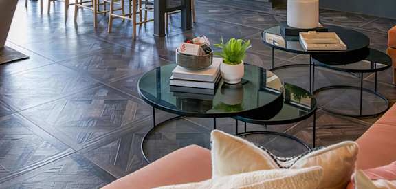 a living room and kitchen with couches and tables