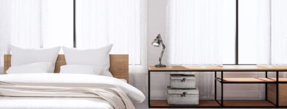a bedroom with a bed and a desk