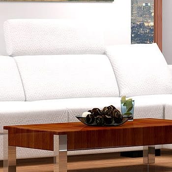 a living room with white couches and a wooden table