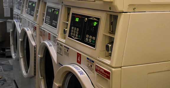 Laundry room with multiple washer and dryer units