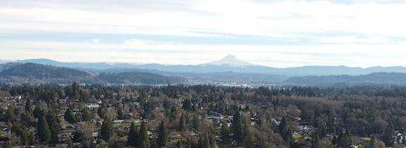 A small town with a mountain in the background.