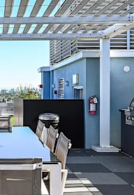 A patio with a table and chairs overlooking a city.