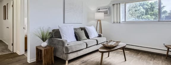 a living room with a couch and a window