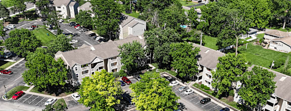 A bird's eye view of a residential area with houses and cars.