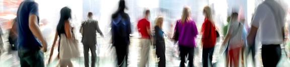 A group of people are walking in a city.