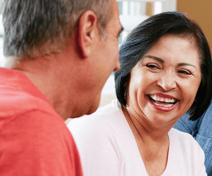 A group of four people are laughing together.