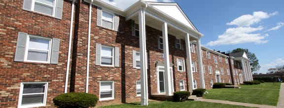 a brick building with white columns
