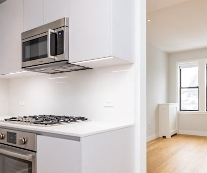 A kitchen with a stove top oven and a microwave.
