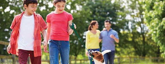 A group of people are walking in a park.