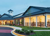 Thumbnail 5 of 5 - a rendering of the exterior of a hospital building at dusk
